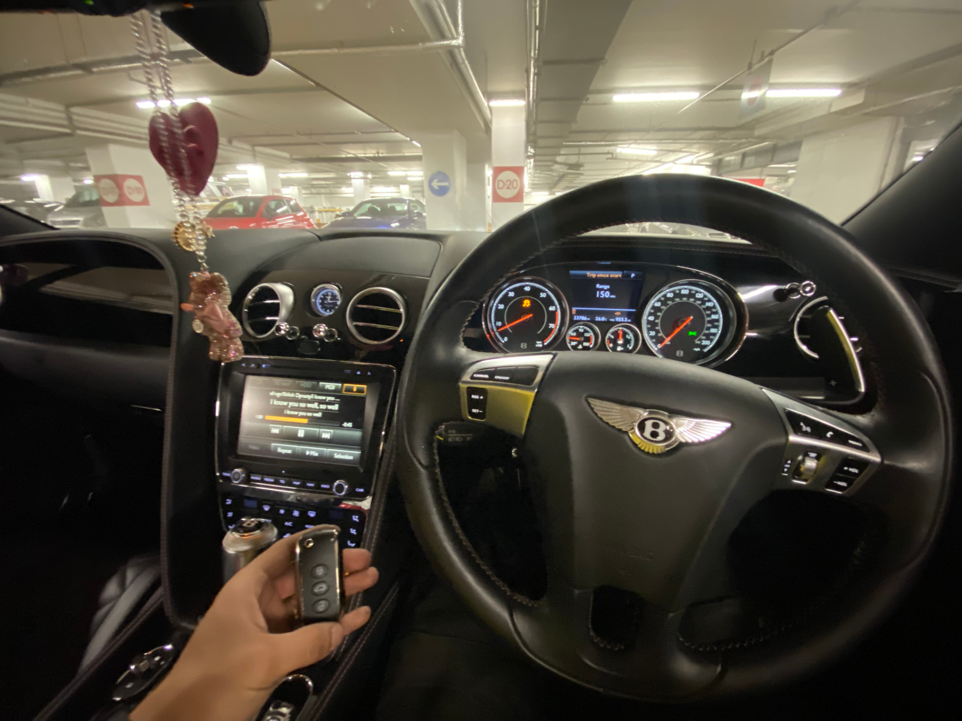 Bentley keys held inside a Bentley at night after key programming